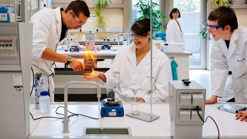 Schüler und Forscherin im Labor